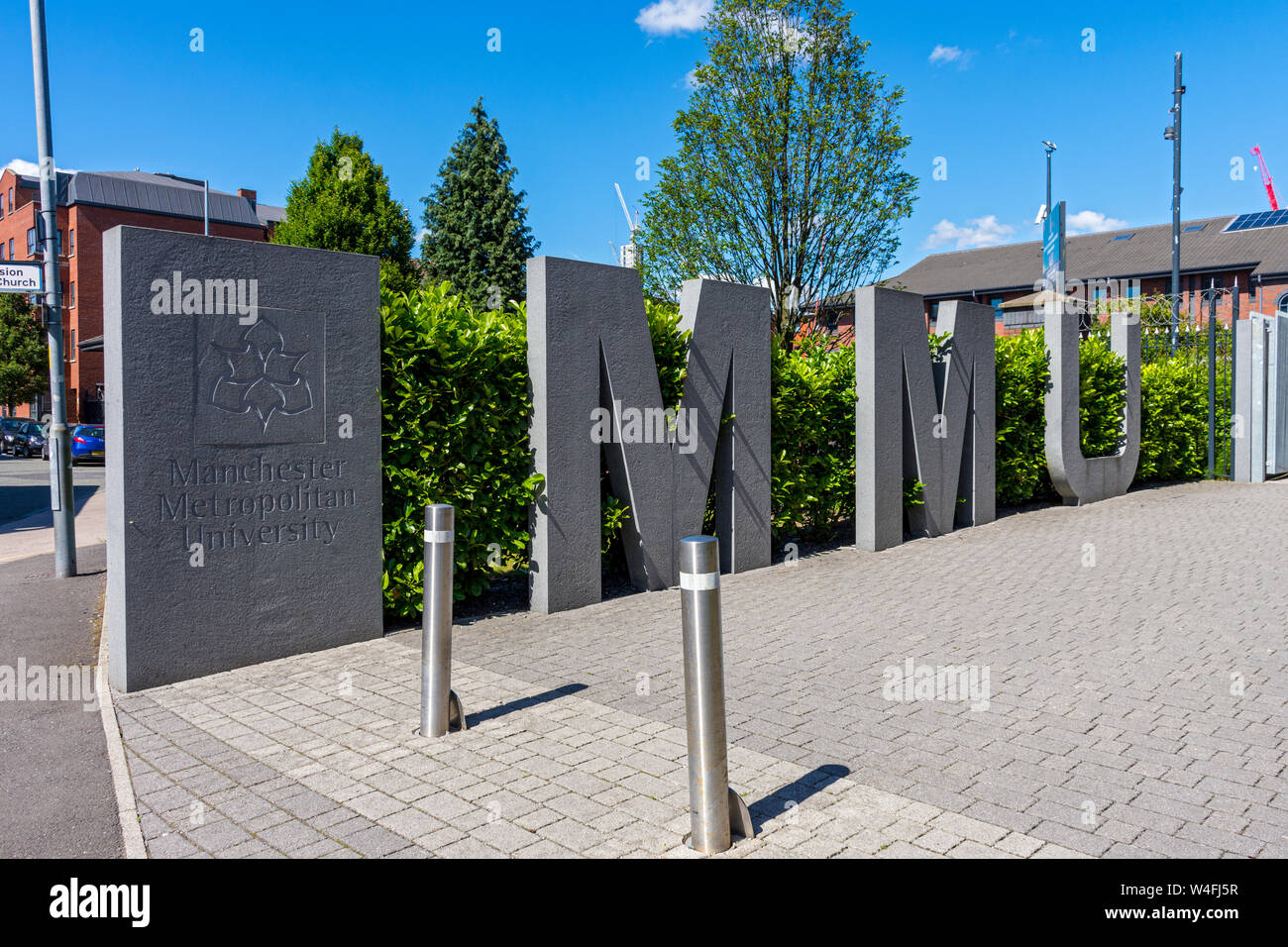 Large stone or concrete MMU sign for Manchester Metropolitan University, on a walkway off Boundary Lane, Manchester, UK Stock Photo