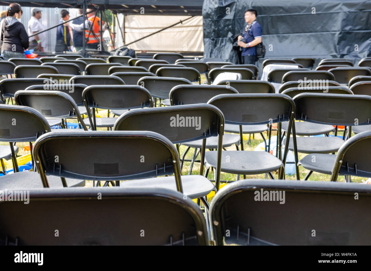 Empty rows of folding chairs at the end of a concert. Stock Photo