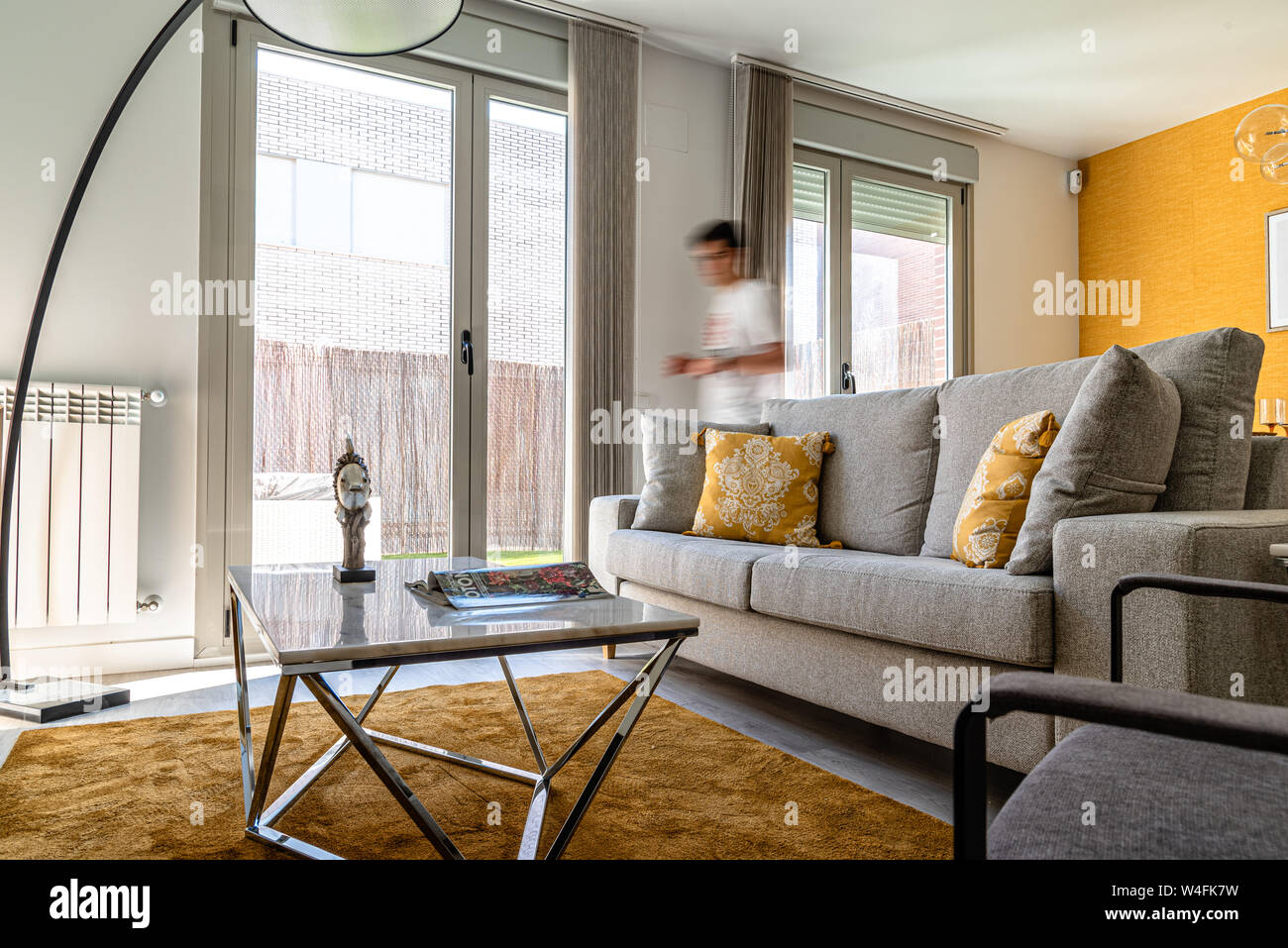 Stylish contemporary living room interior in white and yellow colors with sofa and table. Scandinavian interior design Stock Photo