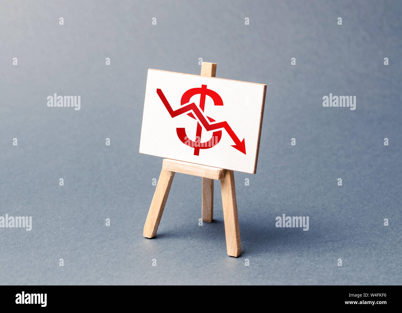 A stand with a canvas and a red dollar arrow down. The concept of falling rates and indicators of the economy or production. low prices and falling de Stock Photo