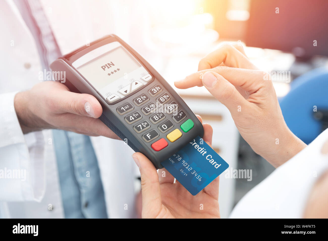 Payment by credit card with terminal. Woman enters the pin code Stock Photo