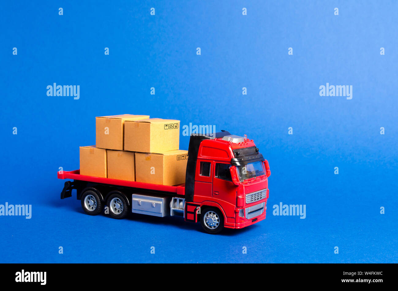 A red truck loaded with boxes. Services transportation of goods and products, logistics and infrastructure. Transportation company. Warehousing and su Stock Photo