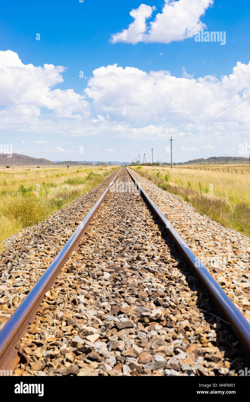 Empty steel railway track in countryside rural farmland area of South Africa Stock Photo