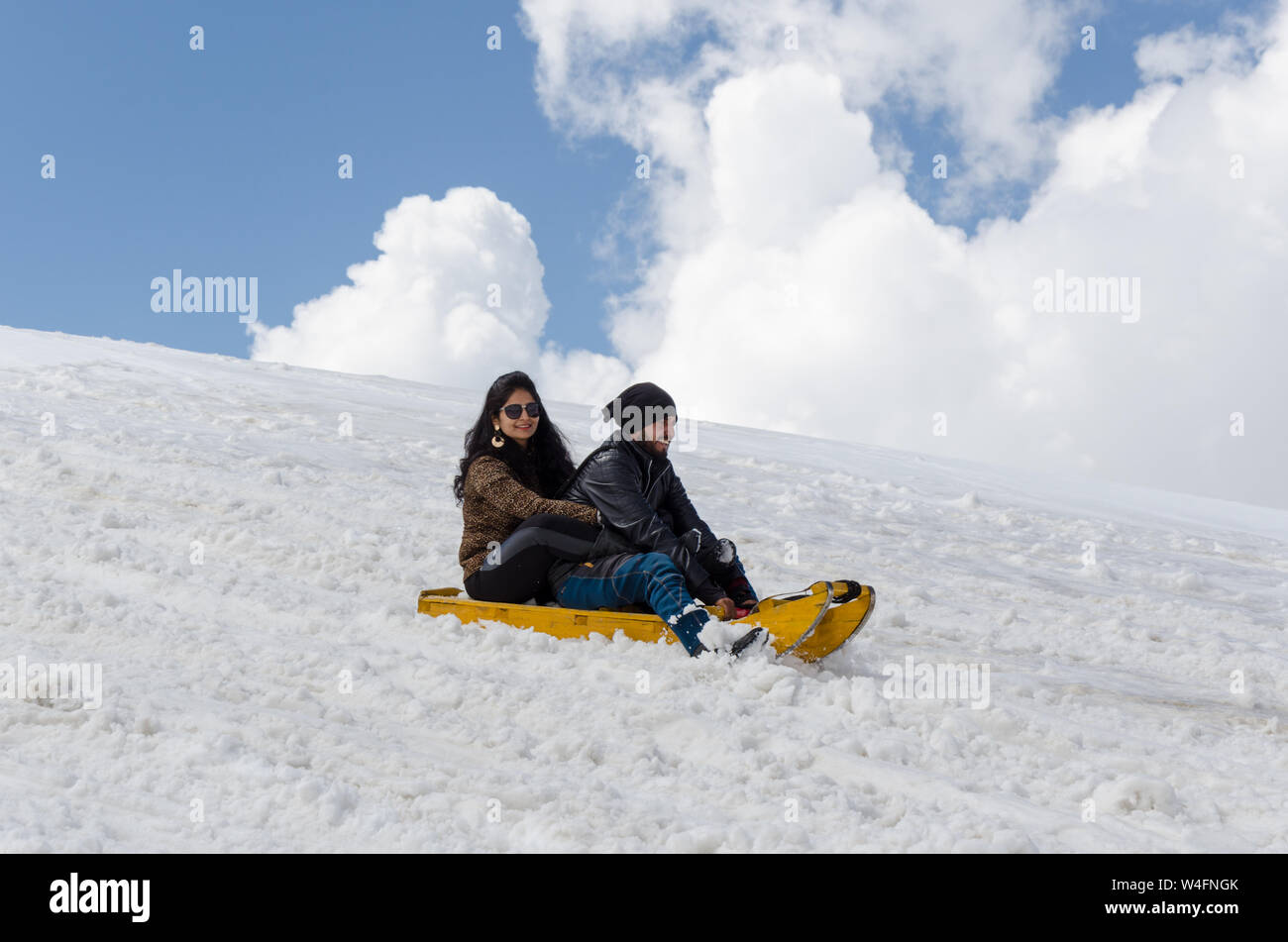 Tourist enjoying sledge ride at Gulmarg Gondola Phase 2 / Apharwat Peak, Gulmarg, Jammu and