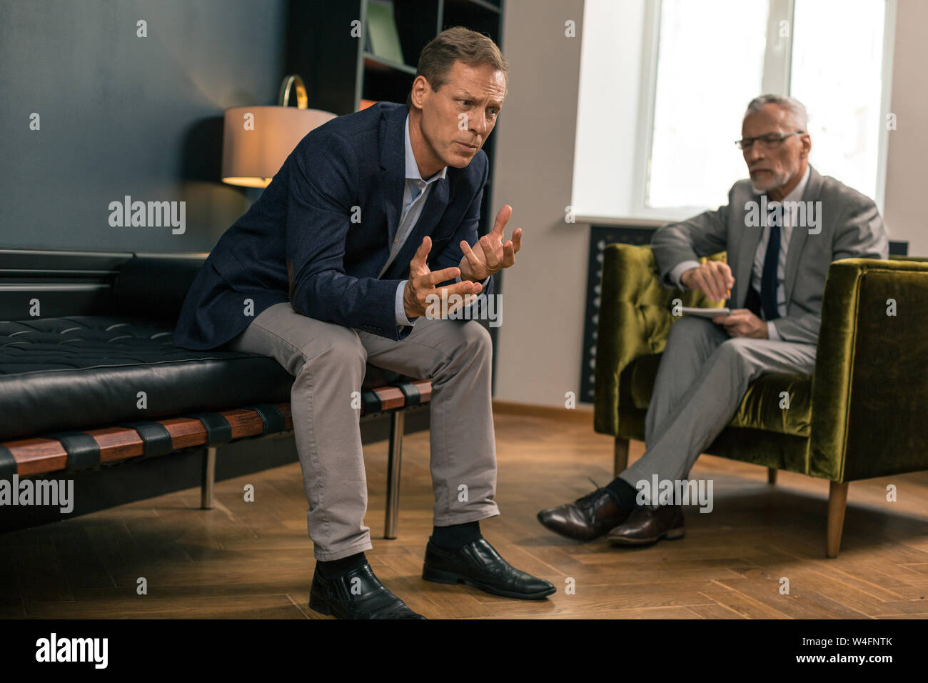 Sad man sitting next hi-res stock photography and images - Alamy