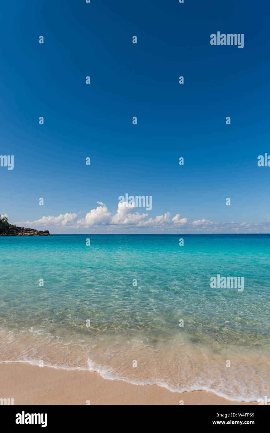 seychelles tropical beach with white sand turquoise water and blue sky ...