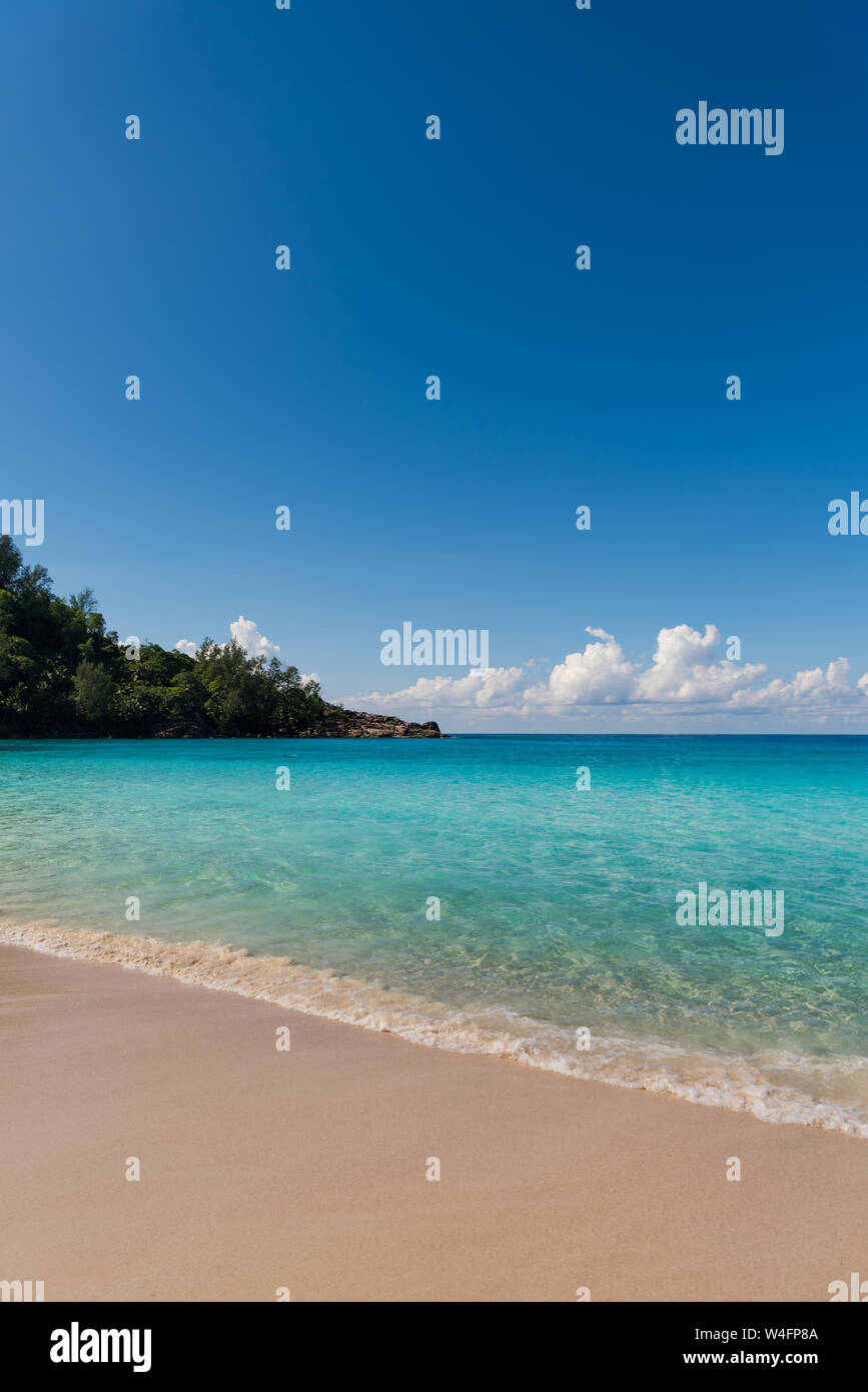 seychelles tropical beach with white sand turquoise water and blue sky ...