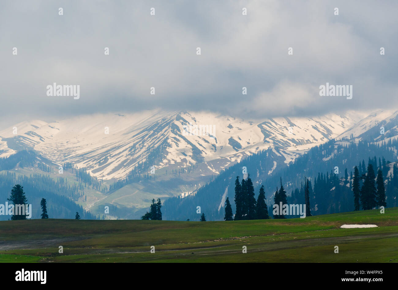 View of snow capped mountains on a cloudy day from Gulmarg Gondola Phase 1 that is Kongdori, Gulmarg, Jammu and Kashmir, India Stock Photo