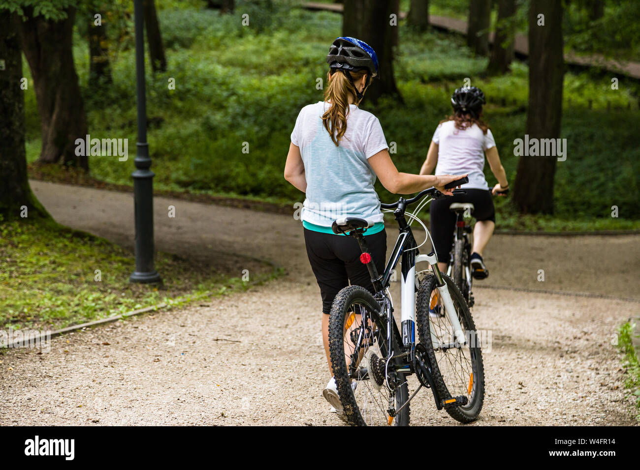 Healthy lifestyle - people riding bicycles in city park Stock Photo