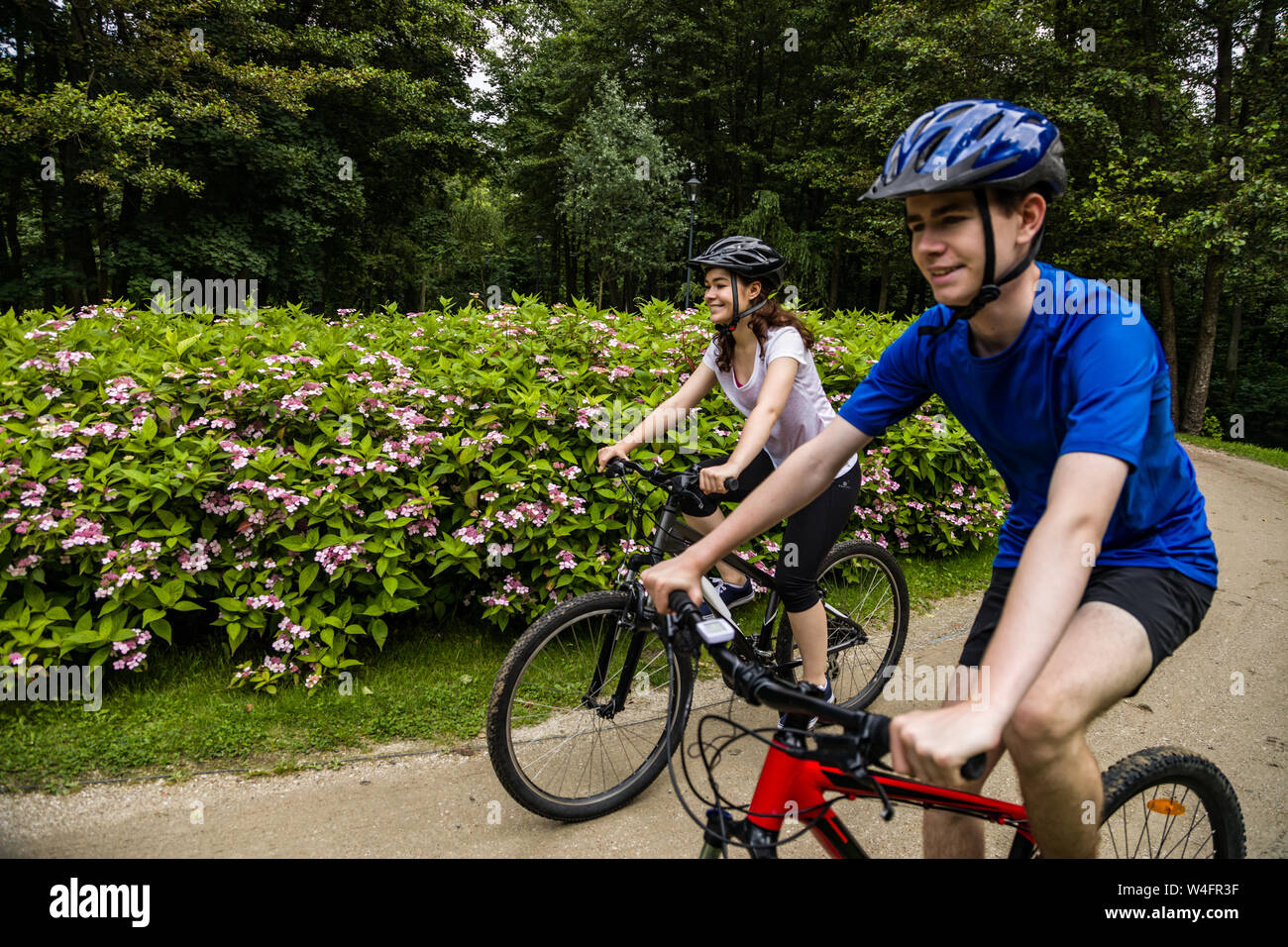 Healthy lifestyle - people riding bicycles in city park Stock Photo