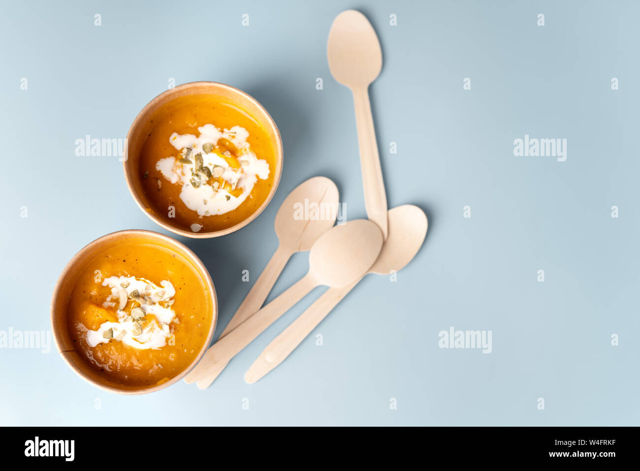 Top view of pumpkin soup in eco craft paper tableware Stock Photo