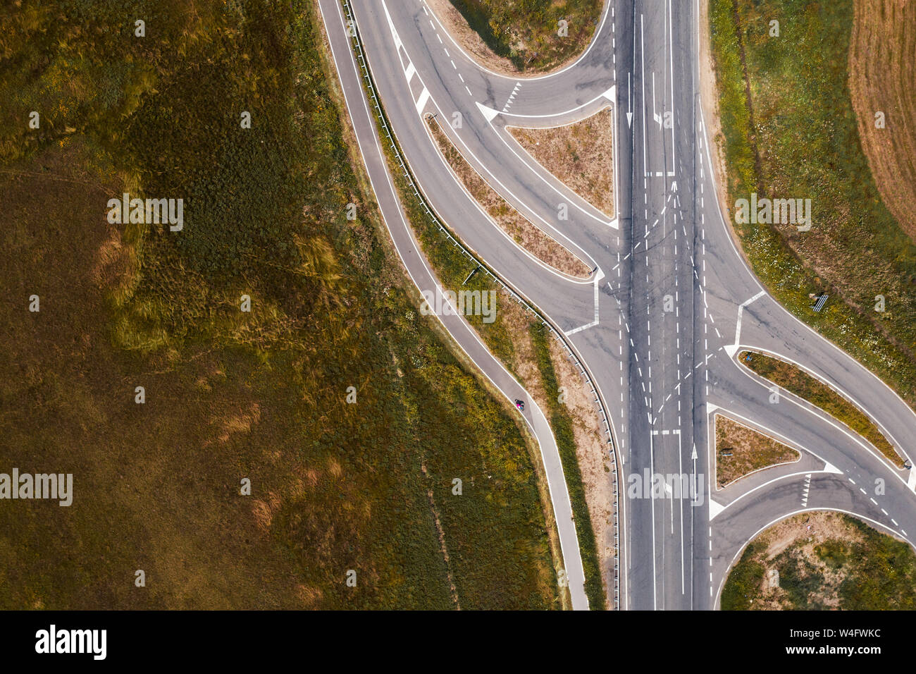 Aerial view of empty road intersection with turning lines from drone
