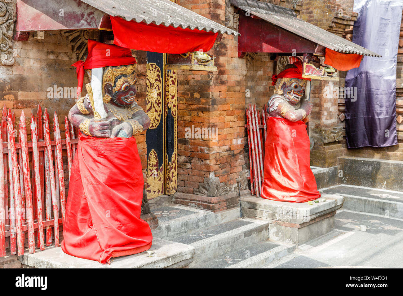 Balinese traditional dvarapala guardian statues near pande (smiths) clan Hindu temple in Munggu, Badung, Bali, Indonesia. Stock Photo