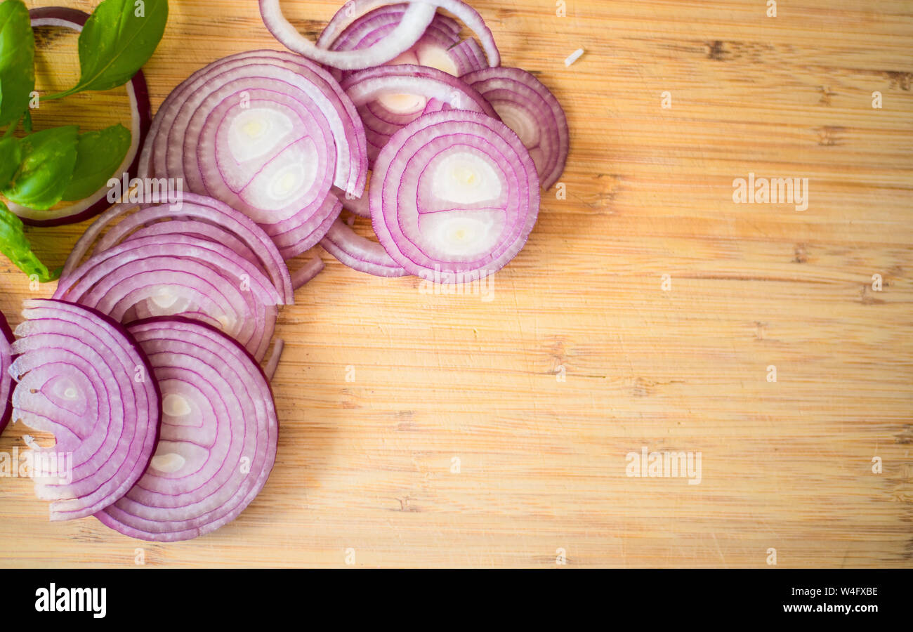 Red onion slices isolated on wooden chopping board Stock Photo - Alamy