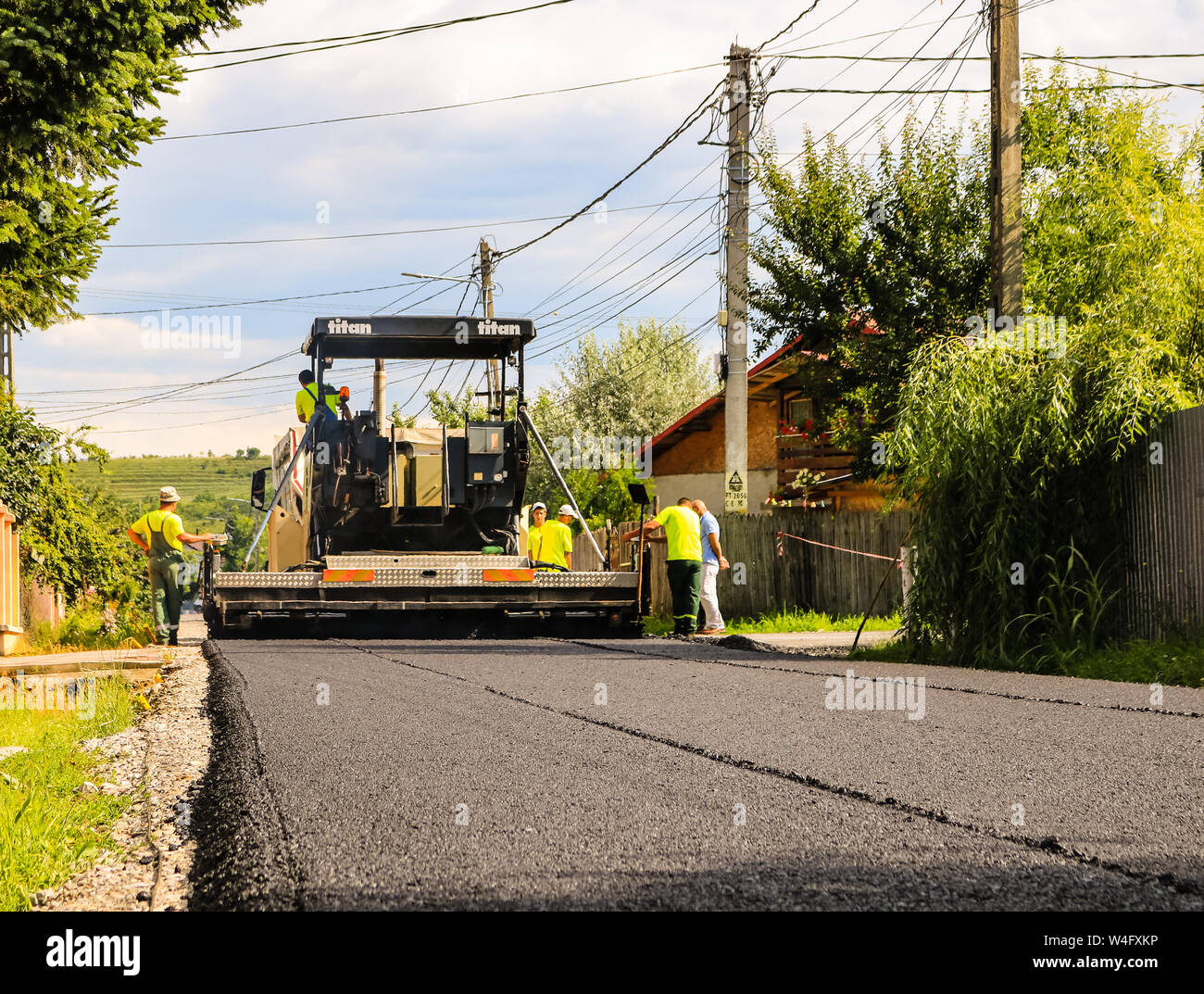 Workers Near The Asphalt Machine Laying The Hot Asphalt With Shovels On 