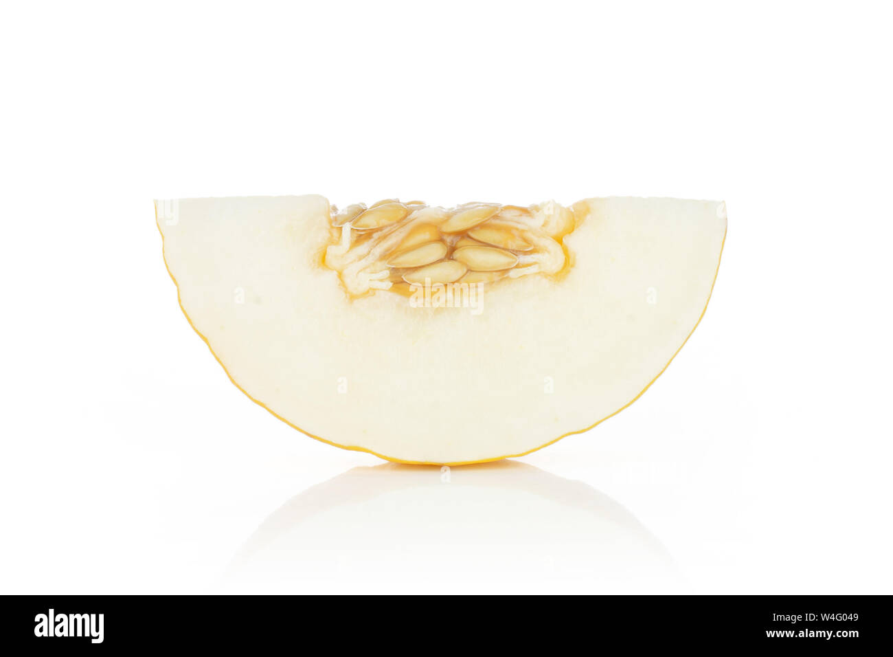 One slice of fresh yellow melon canary with seeds isolated on white background Stock Photo