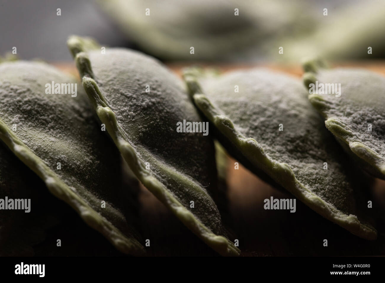 close up view of raw green ravioli in stack Stock Photo - Alamy