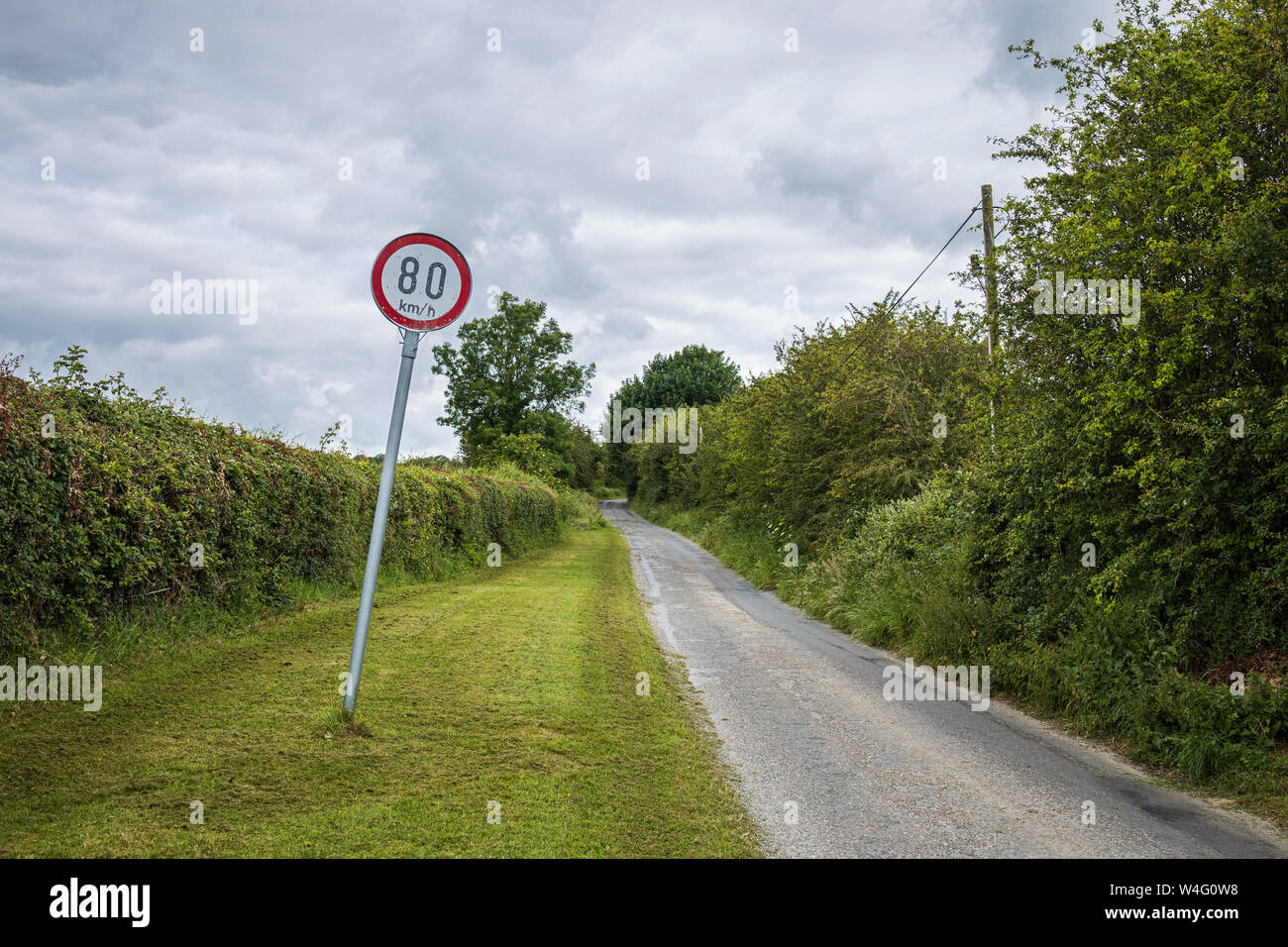 Eighty kilometer per hour speed restriction on a country road in Two Pot House, County Cork, Ireland, Stock Photo