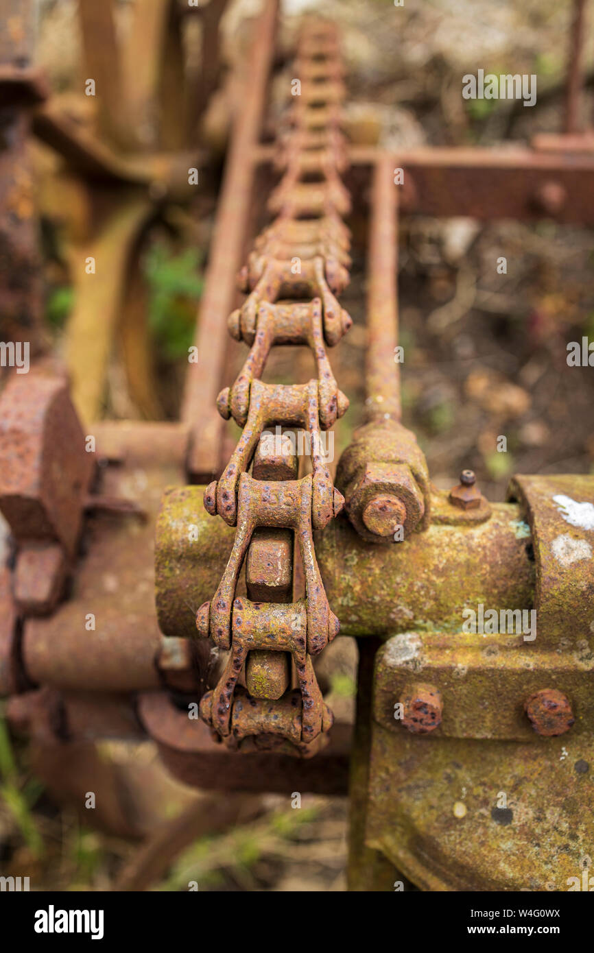 Abandoned Blackstone Digger farm machine, chain drive detail, rusting on a roadside in Two Pot House, County Cork, Ireland, Stock Photo
