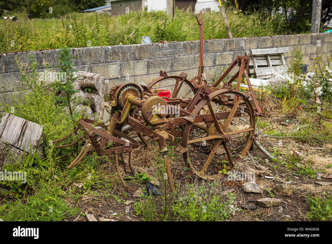 Abandoned Blackstone Digger farm machine rusting on a roadside in Two