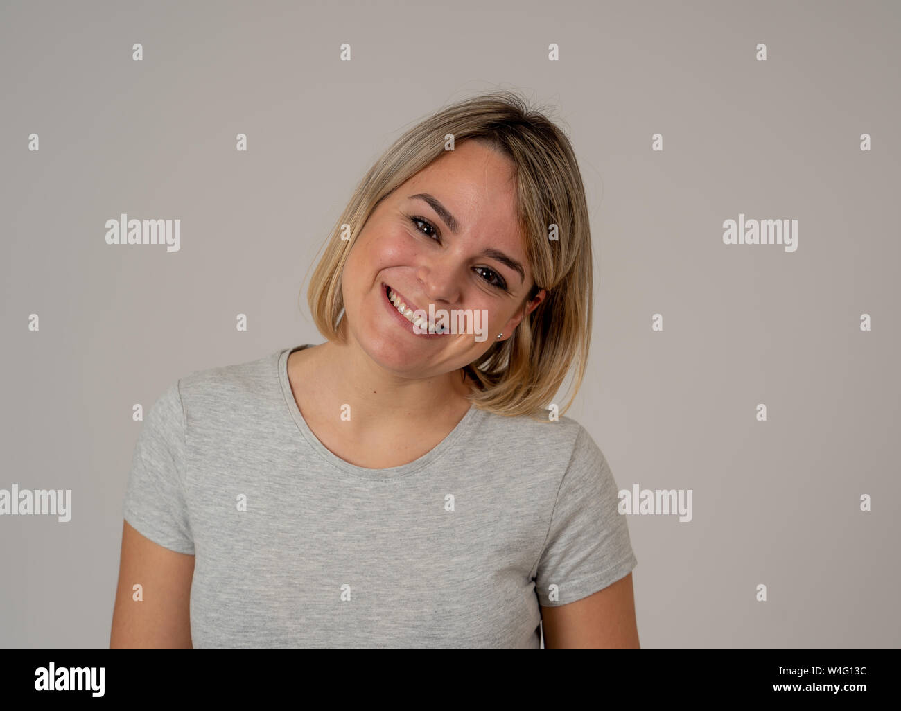 Close up portrait of attractive young pretty caucasian woman with happy face and beautiful smile. Isolated on neutral background. In People, positive Stock Photo