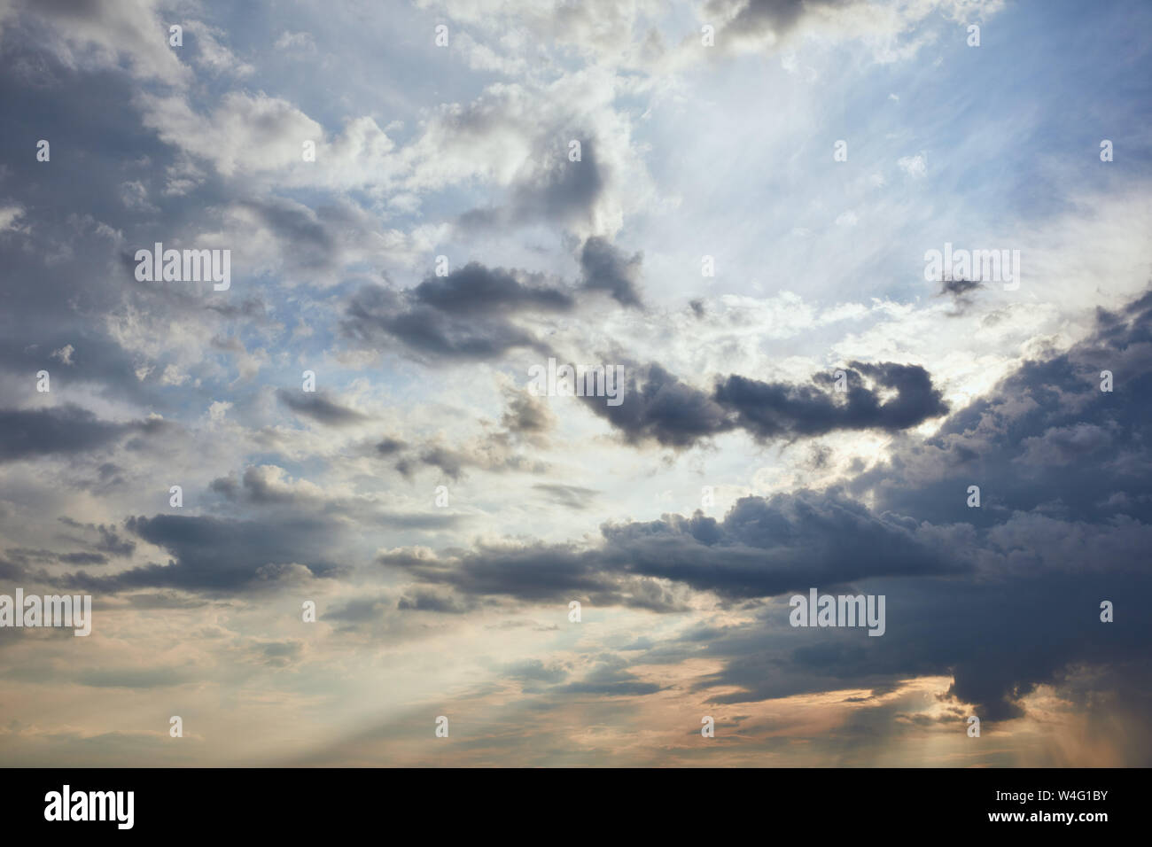 dark clouds and sun rays on blue sky background Stock Photo - Alamy