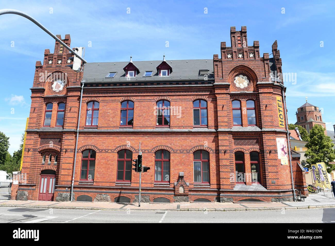 Wolgast, Germany. 10th July, 2019. View of the former imperial post office of the city of Wolgast. In 2013 the post office from 1884 was converted into a hostel with 68 beds. The town on the Peene river to the island of Usedom has around 13,000 inhabitants. In 1282 the town was granted the town charter according to the Lübeck model. Credit: Stefan Sauer/dpa-Zentralbild/ZB/dpa/Alamy Live News Stock Photo