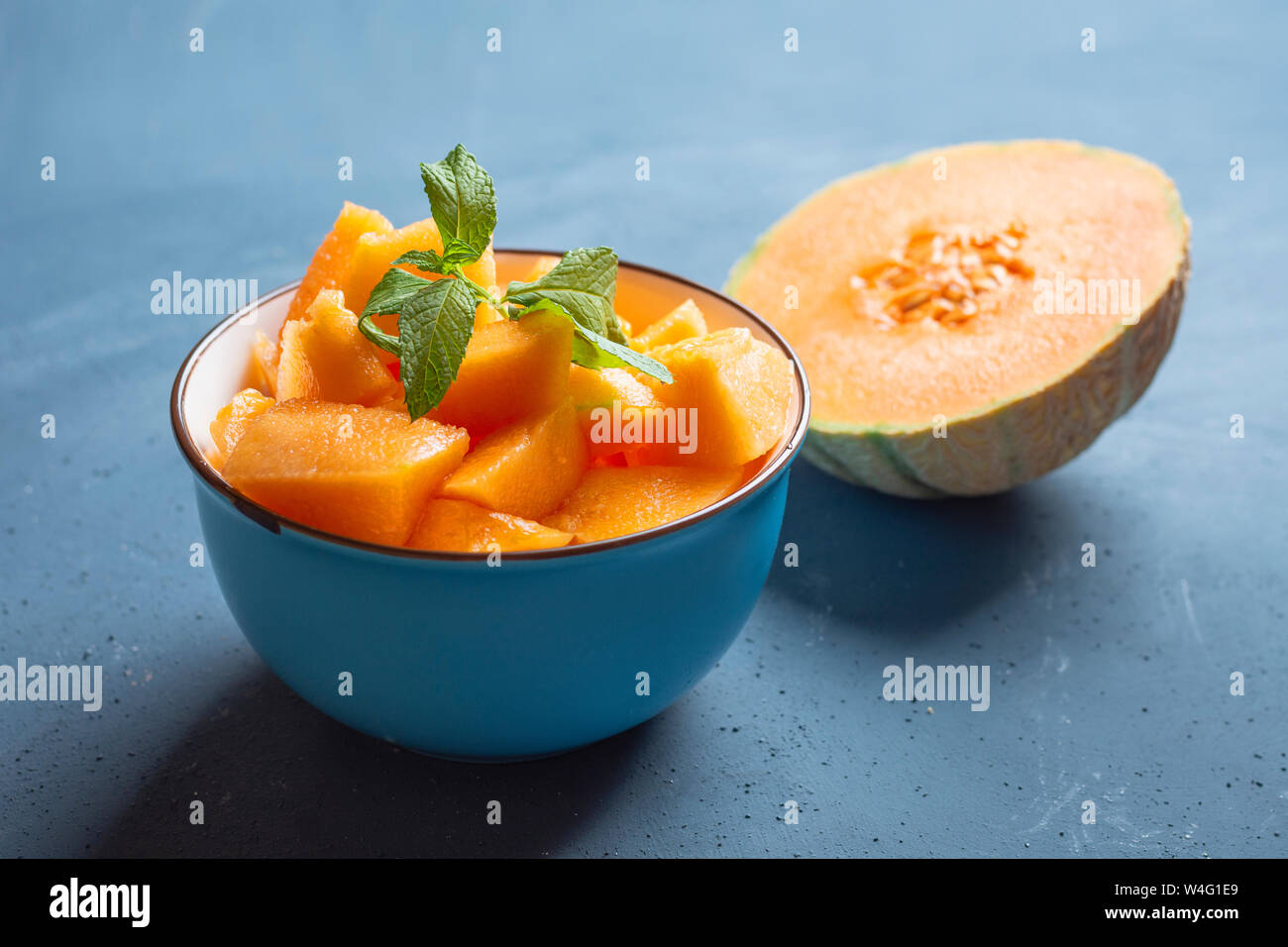 Fresh melon cut into pieces in a bowl Stock Photo