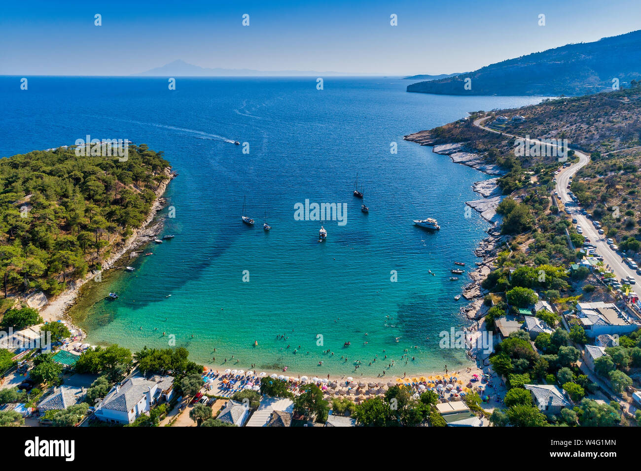 Aerial View of the Aliki Beach with colorful umbrellas, at Thassos island, Greece. swimming people in sea Stock Photo