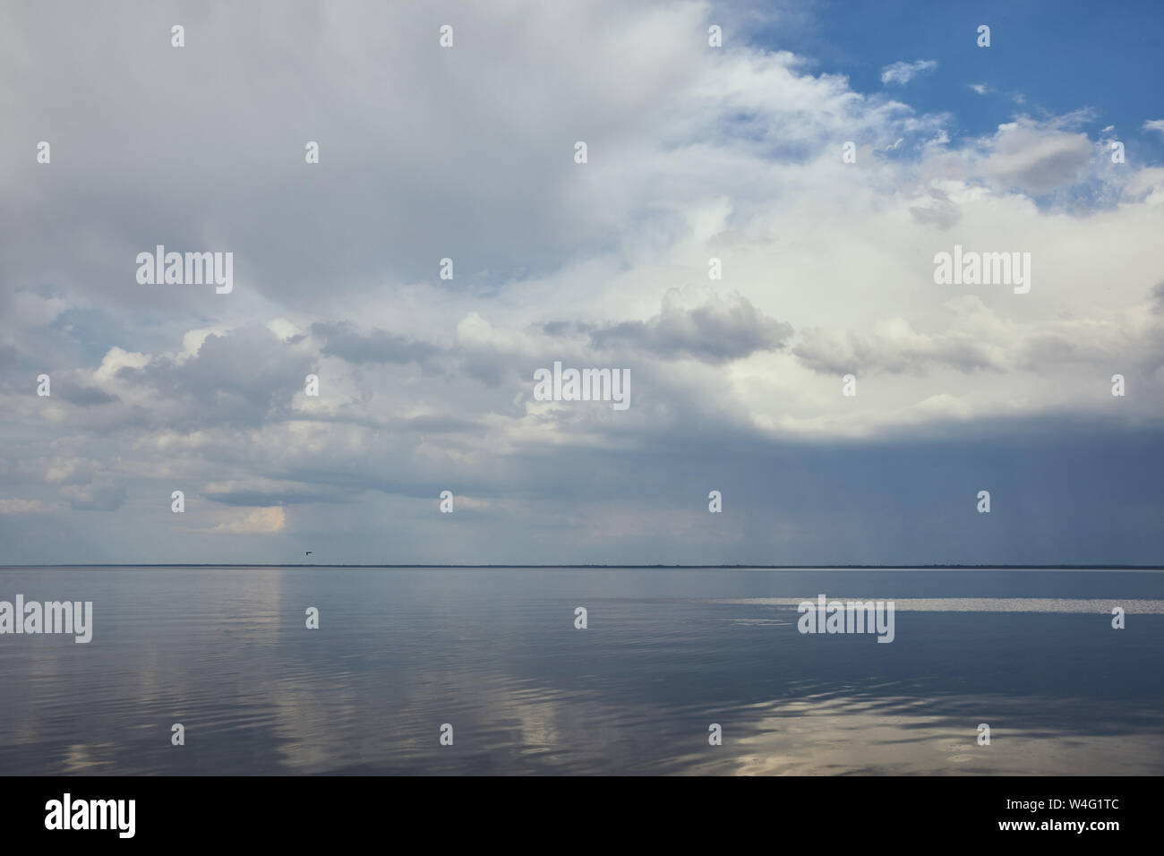 Peaceful blue sky with white clouds reflected in river water Stock ...