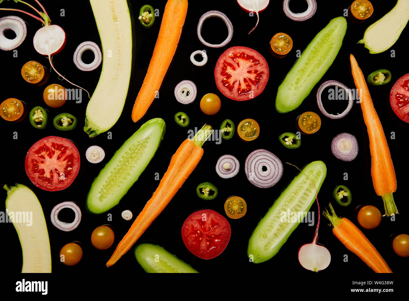 top view of fresh sliced vegetables isolated on black Stock Photo - Alamy