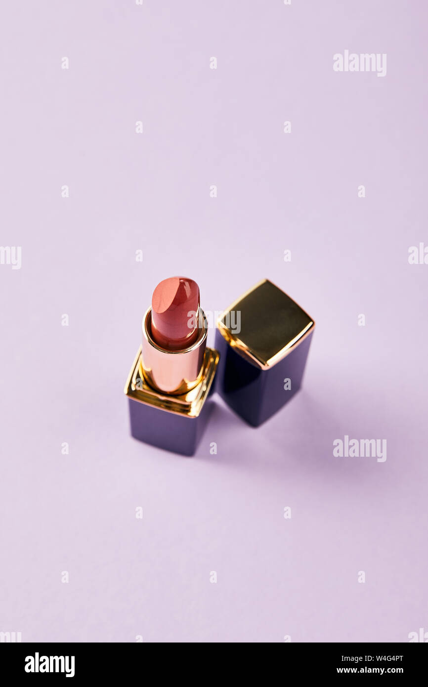 Download High Angle View Of Single Opened Tube Of Red Lipstick On Purple Stock Photo Alamy Yellowimages Mockups