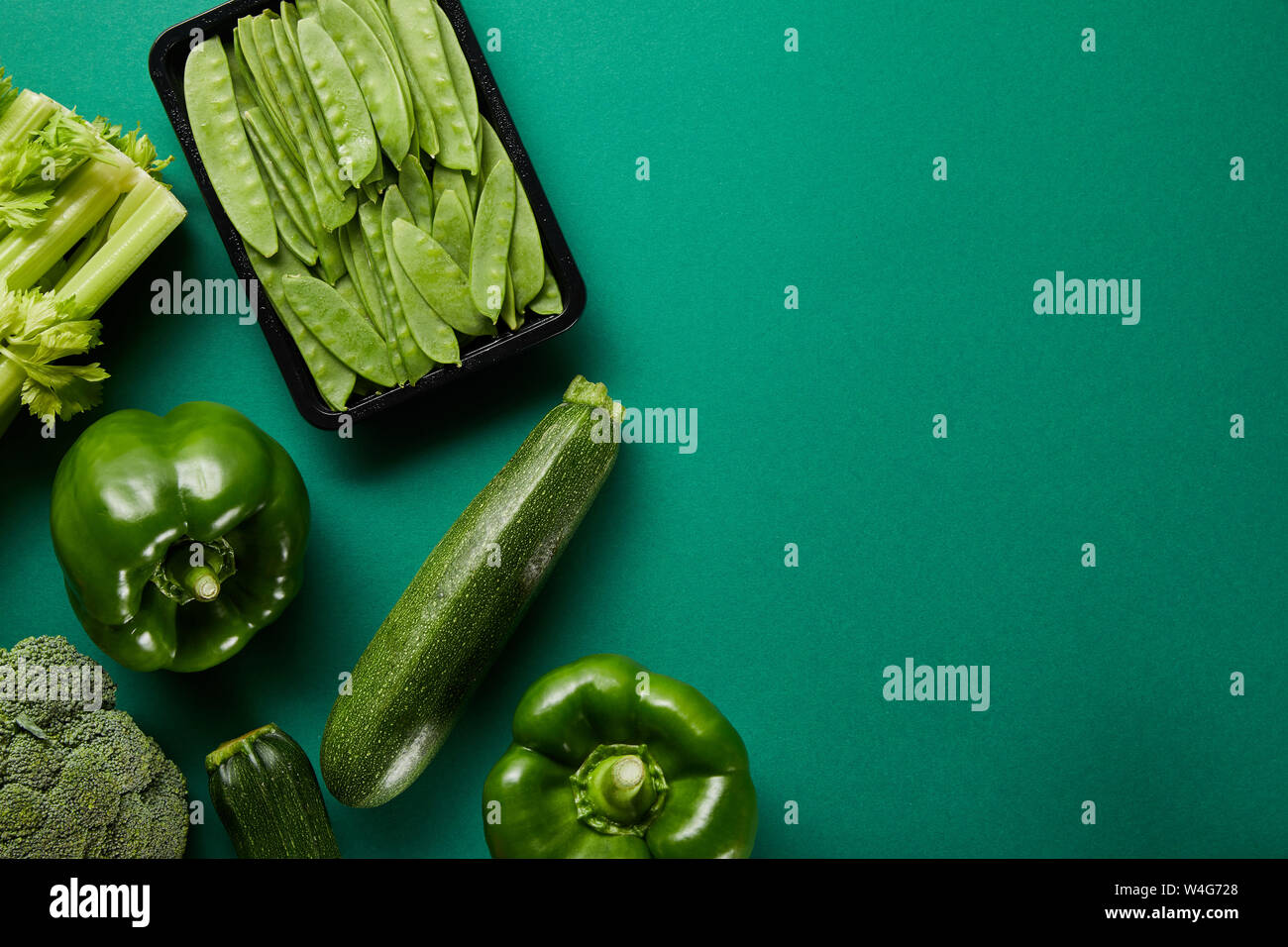 top view of green fresh vegetables on green background Stock Photo - Alamy