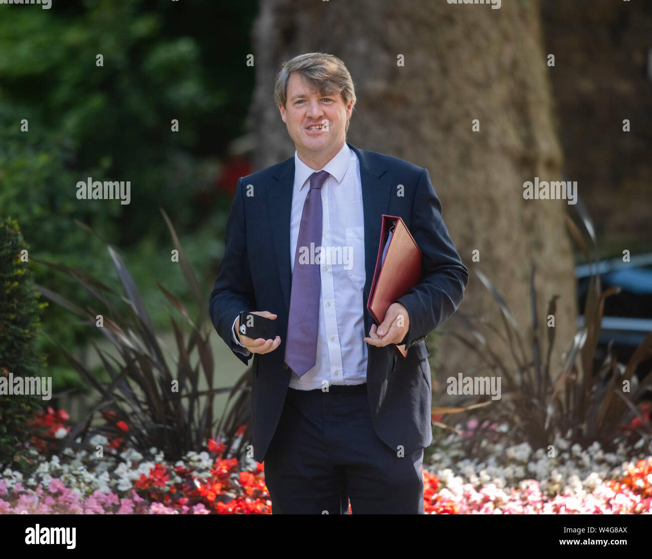 Downing Street, London, UK. 23rd July 2019. Chris Skidmore, Minister of State for Universities, Science, Research and Innovation arrives in Downing Street for final cabinet meeting before Boris Johnson is announced as new PM. He takes phone photos of the large press contingent. Credit: Malcolm Park/Alamy Live News. Stock Photo