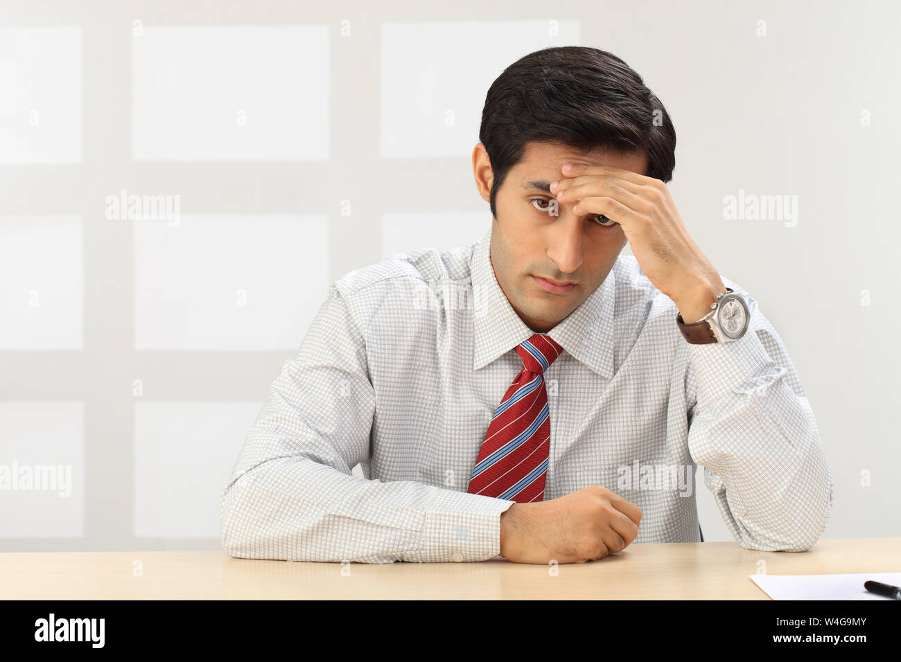 Indian businessman suffering from headache Stock Photo - Alamy