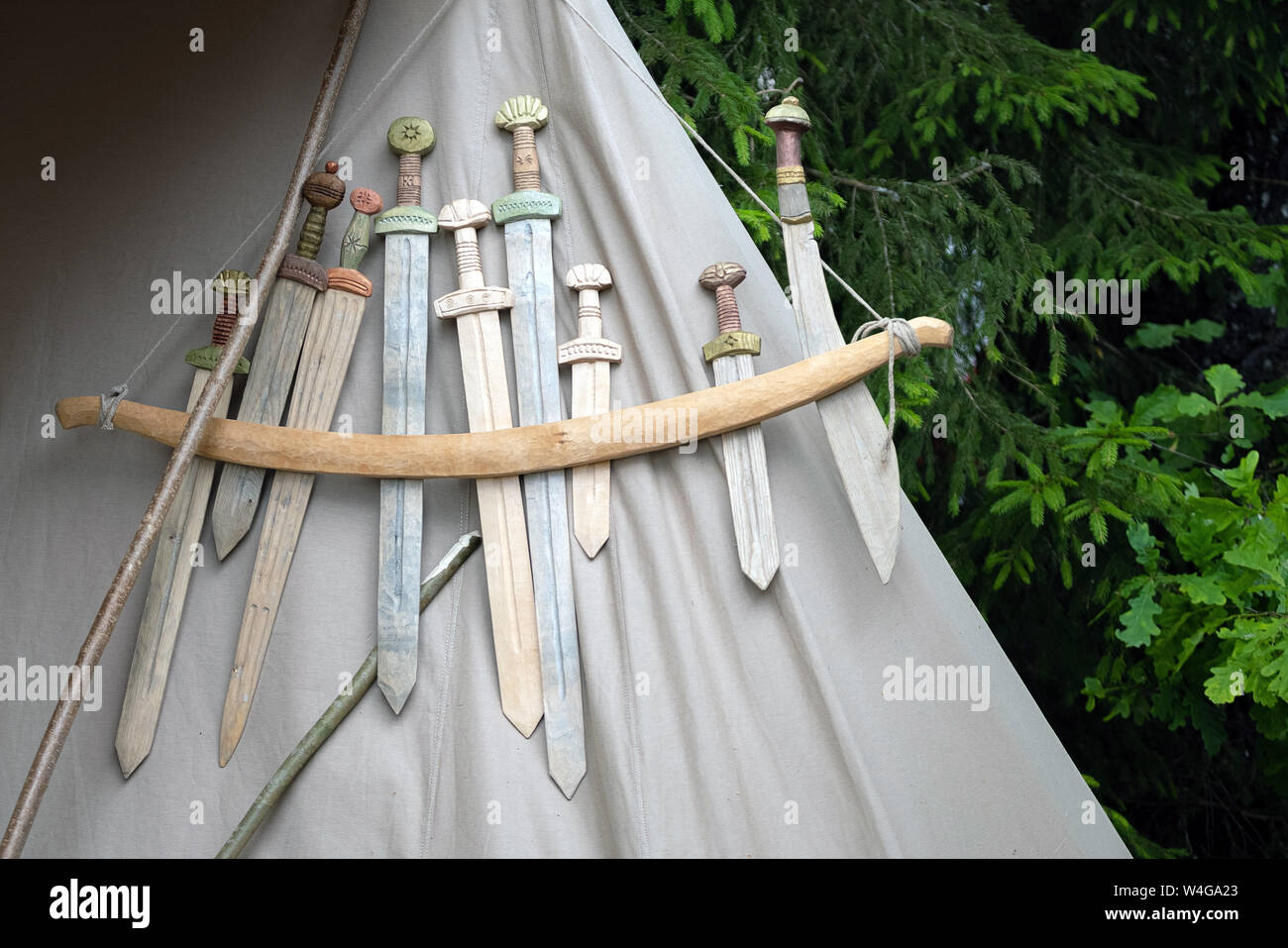 Wooden medieval weapons replicas for close combat displayed on grey fabric texture Stock Photo