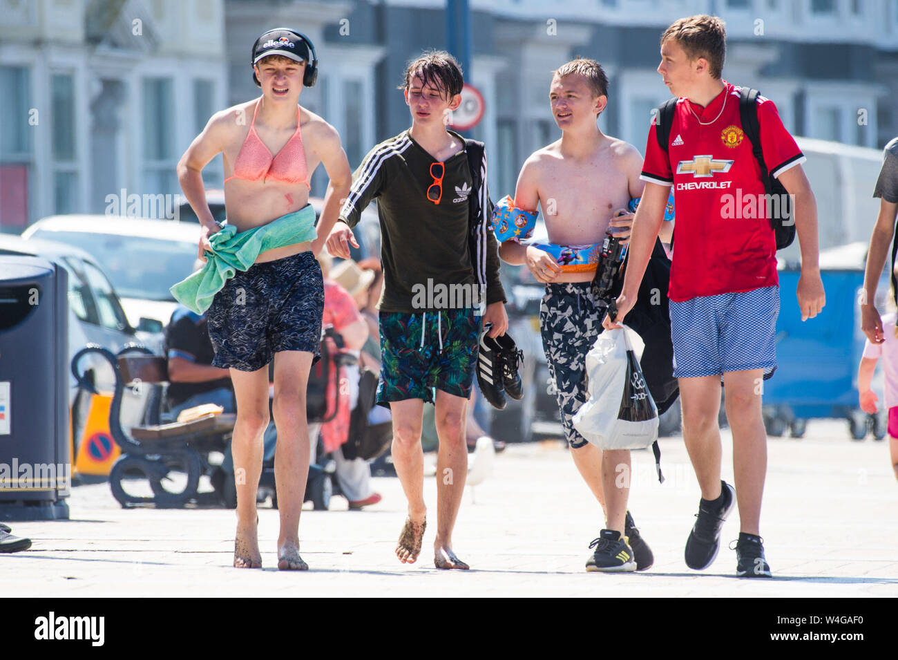 Tuesday 23 July  2019. Aberystwyth Wales UK UK weather: People at the seaside  in Aberystwyth enjoying  a sweltering summer afternoon on a day of unbroken blue skies and hot sunshine. The country is experiencing  the hottest day of the year so far as a plume of scorching hot air drifts in from the continent.  Photo credit Keith Morris / Alamy Live News Stock Photo