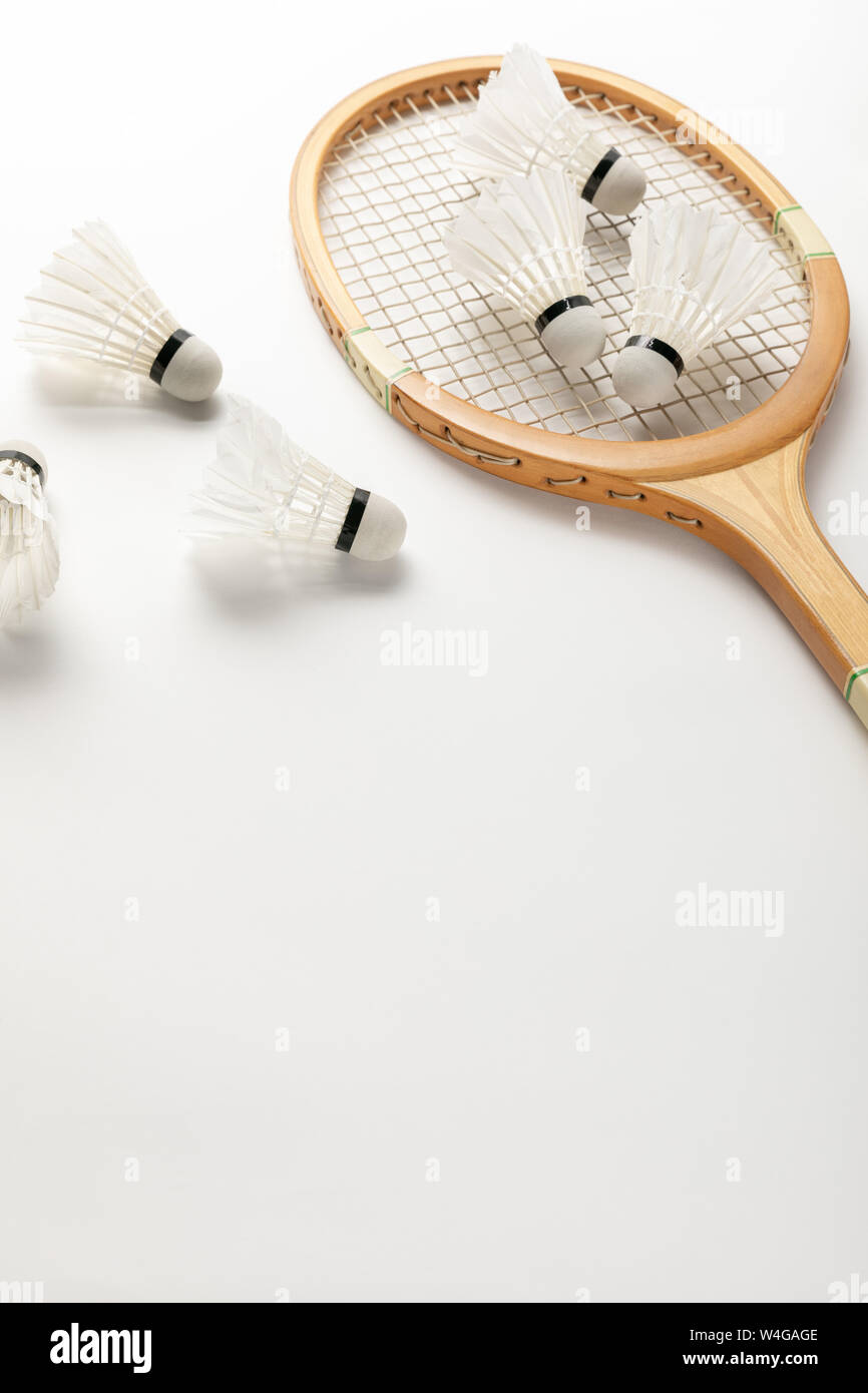 close up view of wooden badminton racket and shuttlecocks on white background with copy space Stock Photo