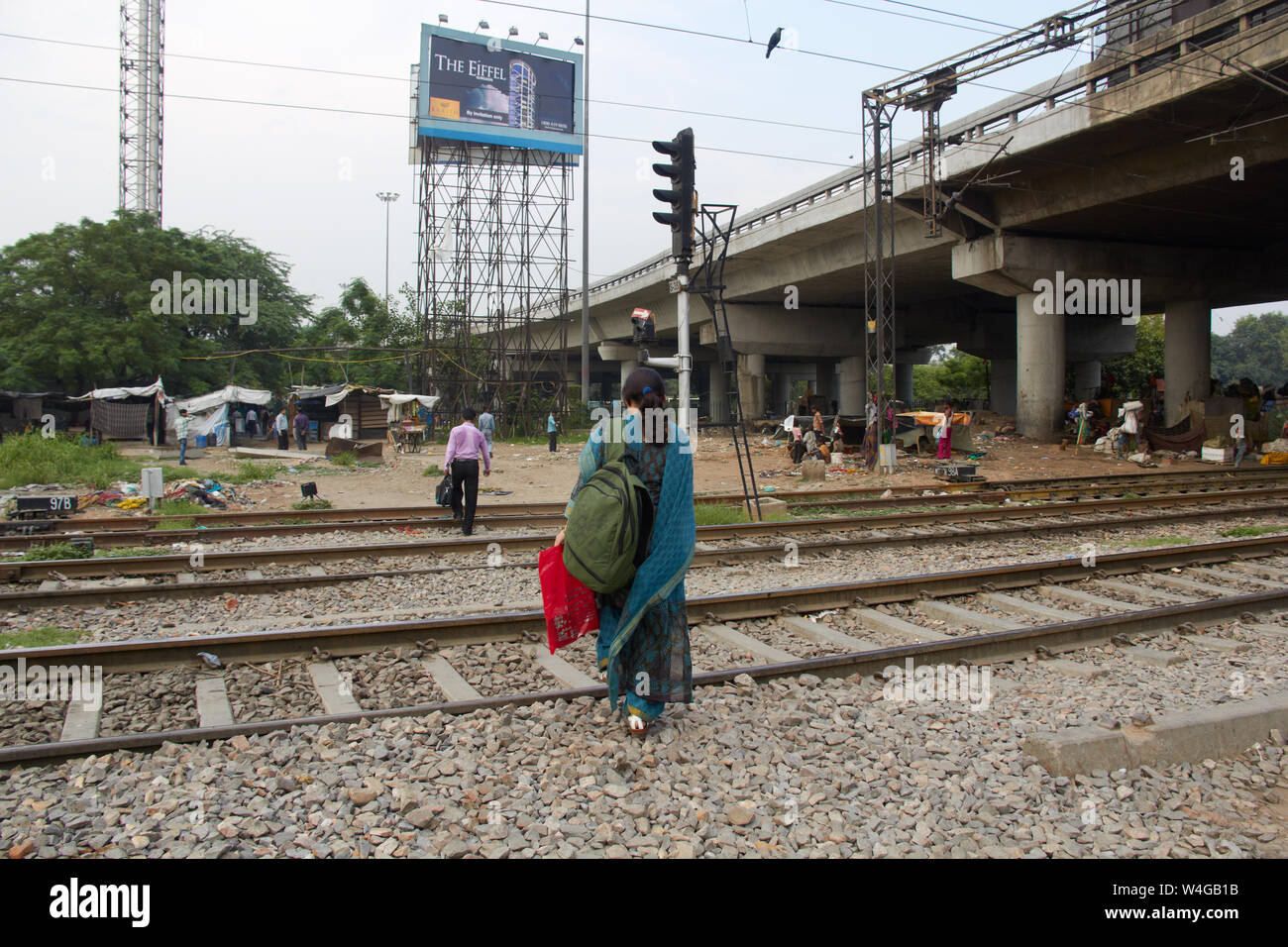 Woman crossing railway tracks, Delhi, India Stock Photo
