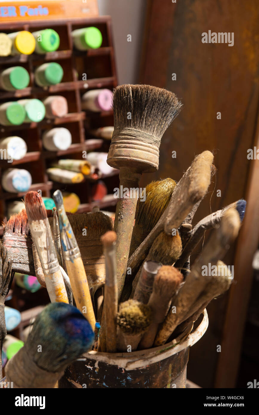Painter's brush and colours in a artist's studio. Stock Photo