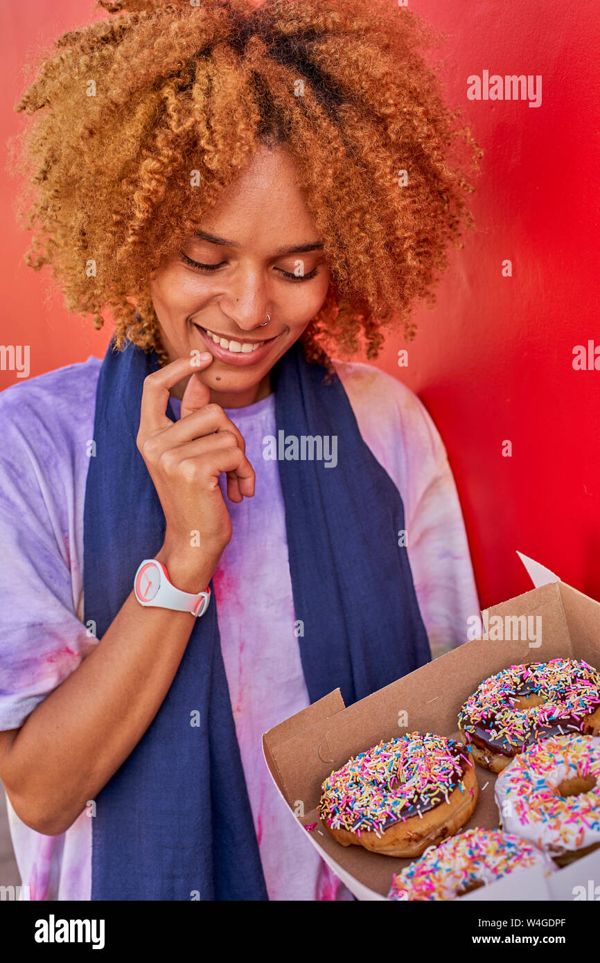 Woman deciding which donut to choose Stock Photo