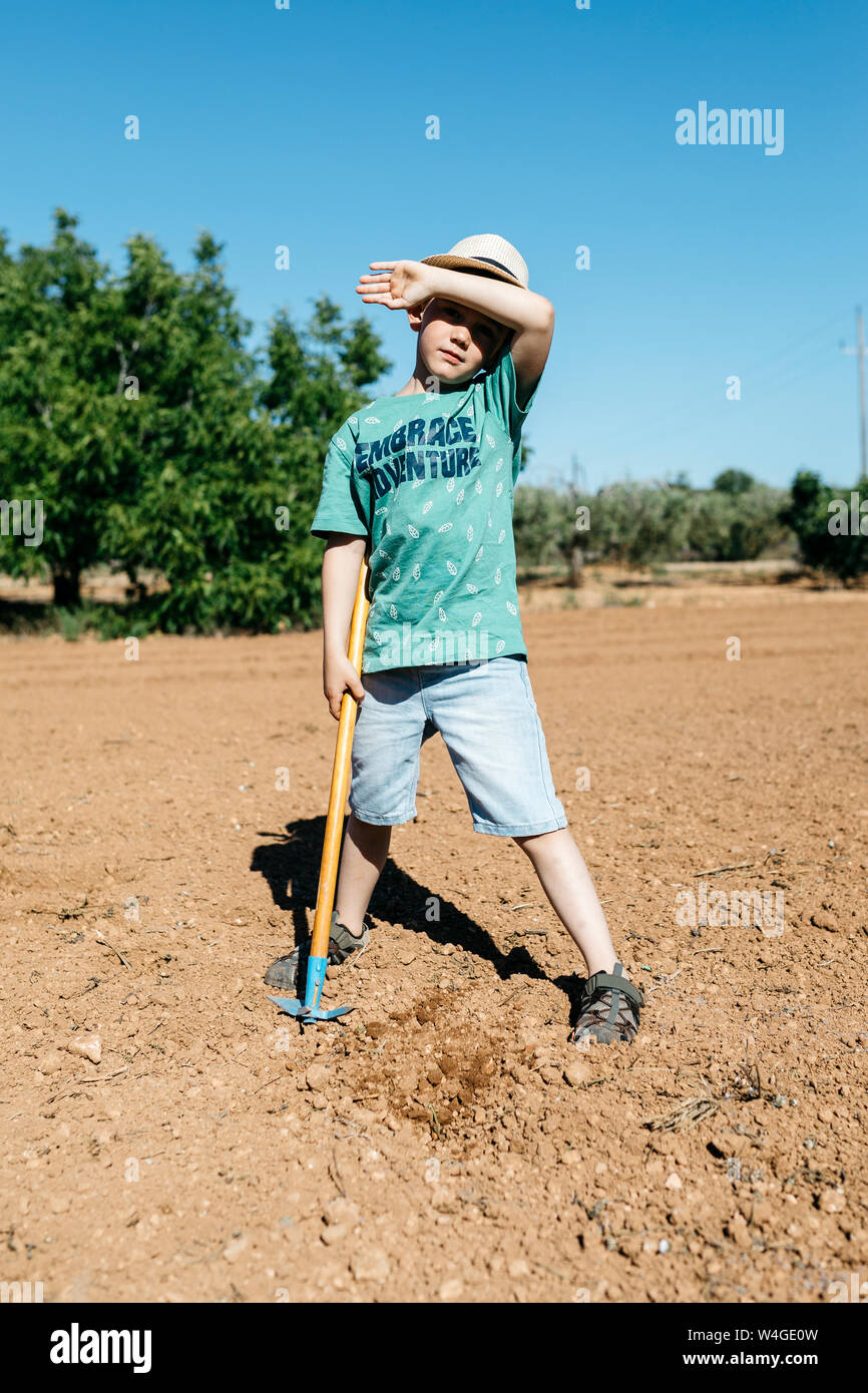 Young gardener drying the sweat of his forehead while he is working Stock Photo