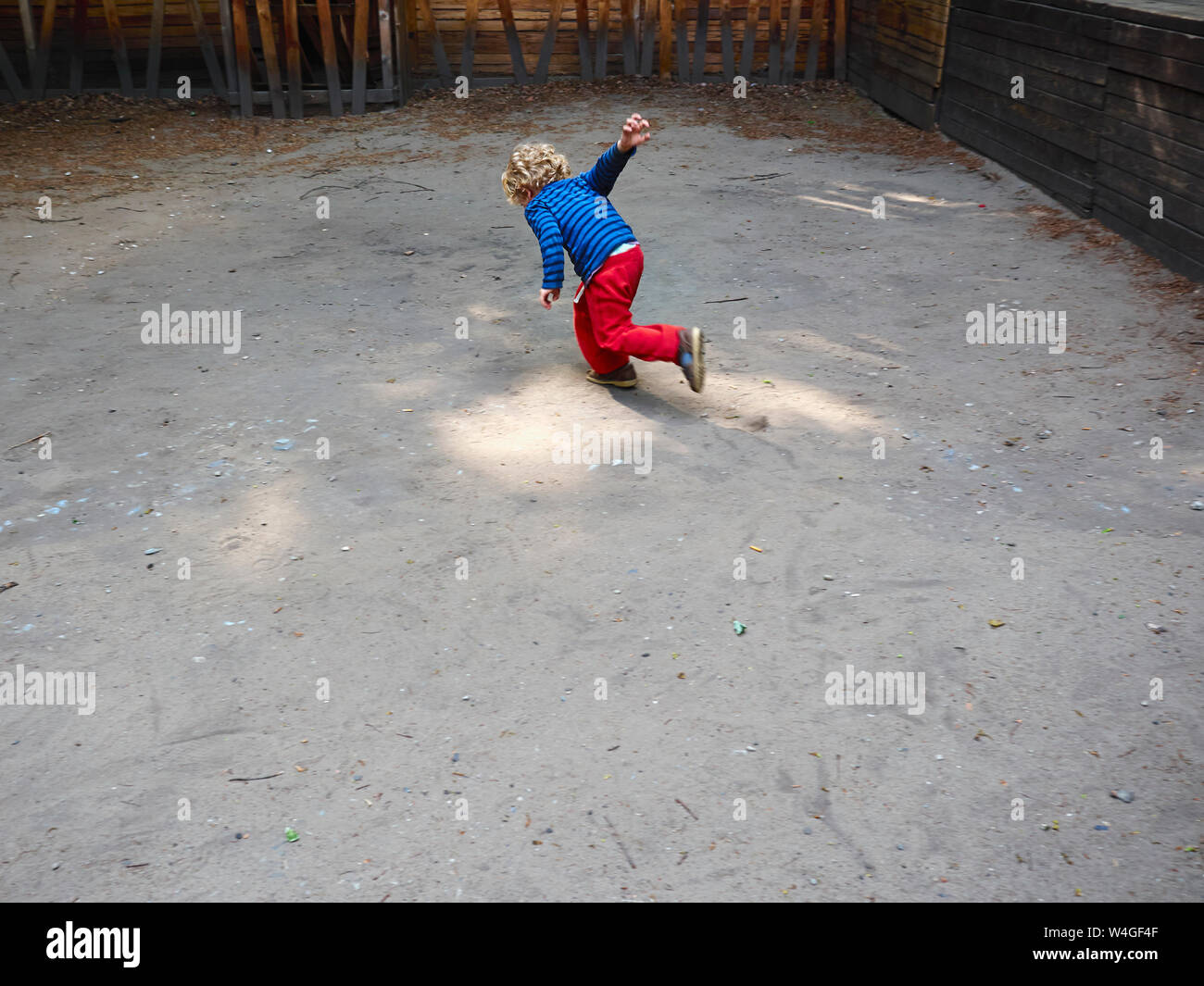 Back view of running little boy on playground Stock Photo