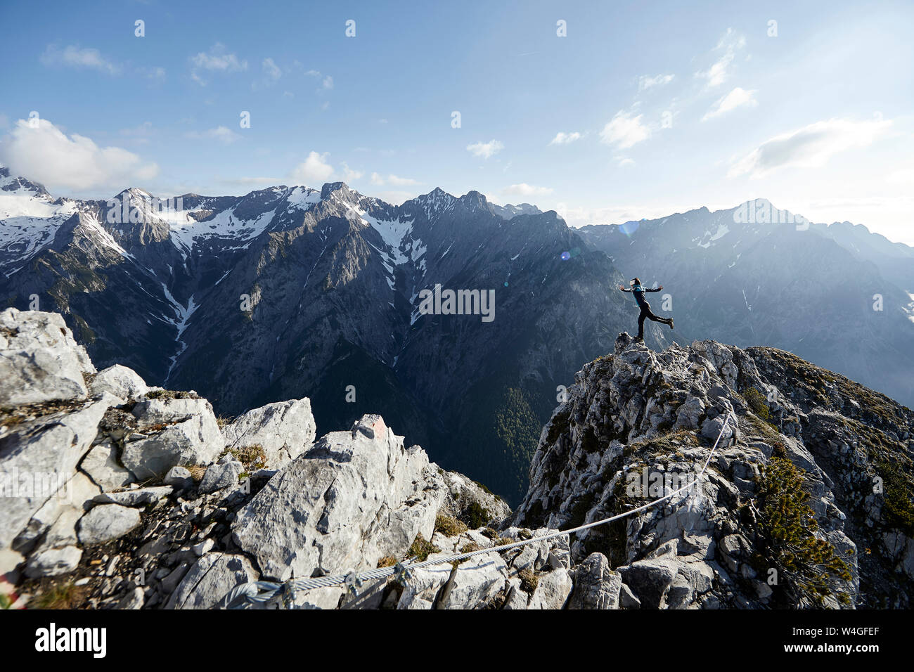 Austria, Tyrol, Gnadenwald, Hundskopf, female climber standing on one leg Stock Photo
