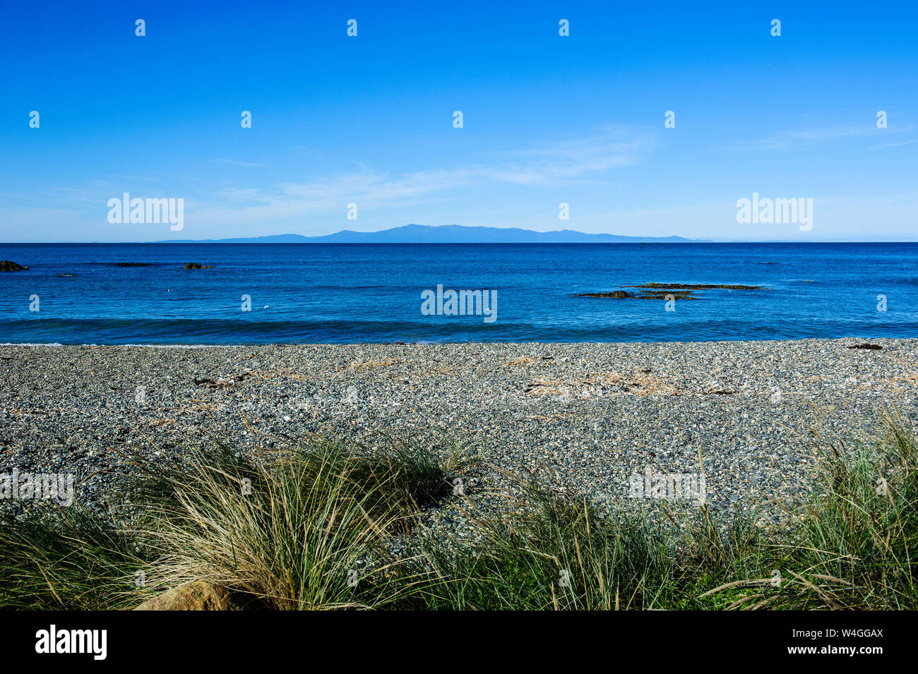 Taramea Bay in Riverton with a view on Stewart Island, South Island, New Zealand Stock Photo