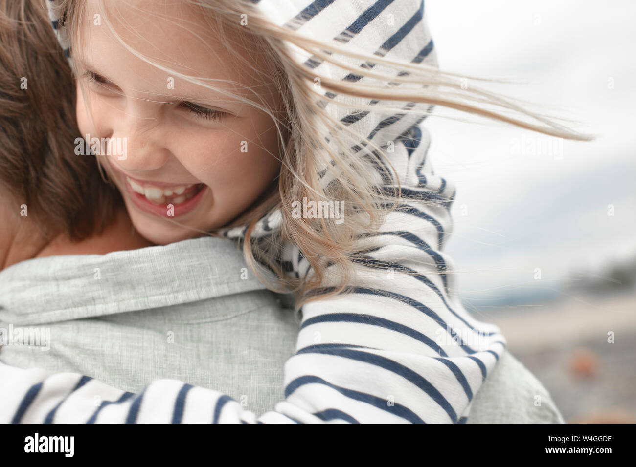 Close-up of happy daughter in her father's arms Stock Photo
