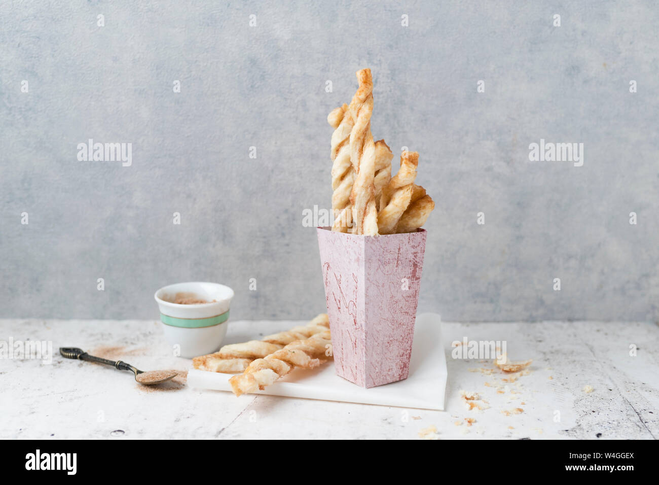 Paperbag of puff pastry sticks with sugar and cinnamon Stock Photo Alamy