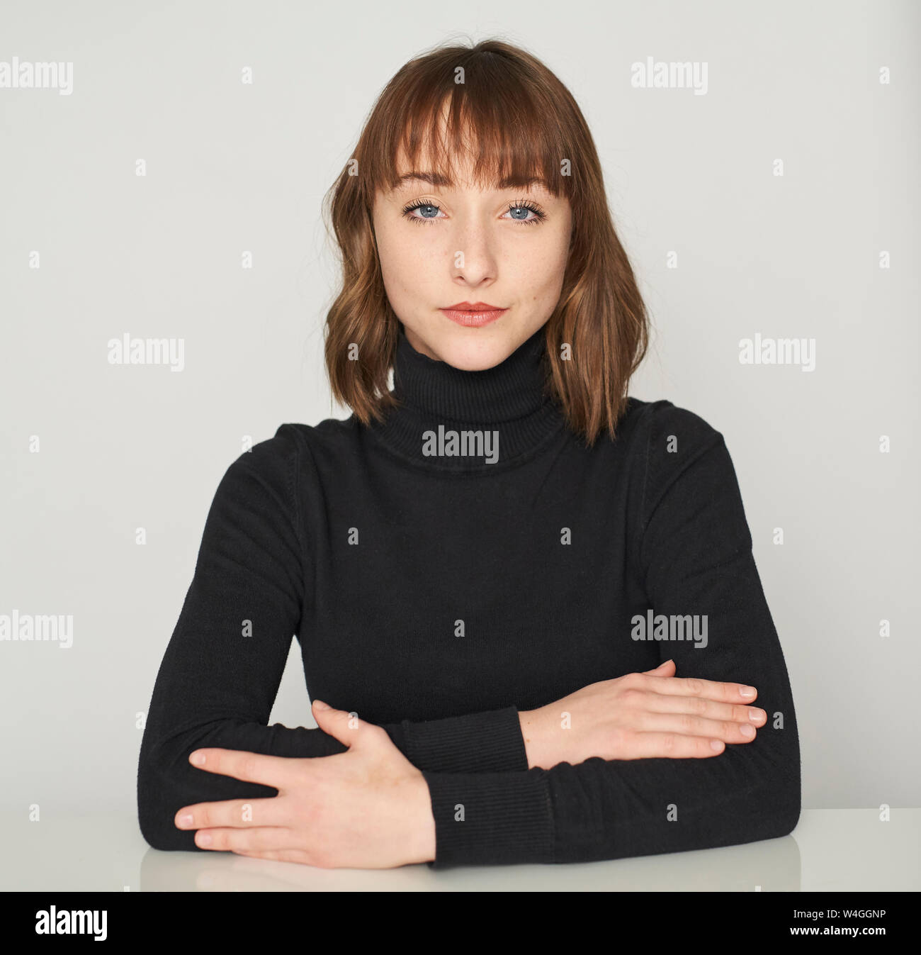 Portrait of serious young woman wearing black turtleneck pullover Stock Photo