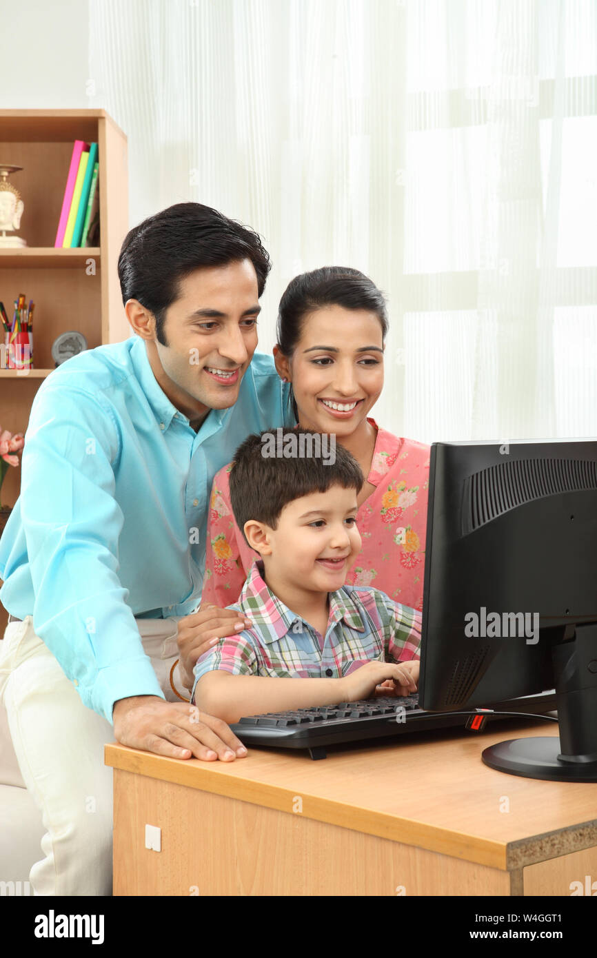 Family using a computer Stock Photo - Alamy