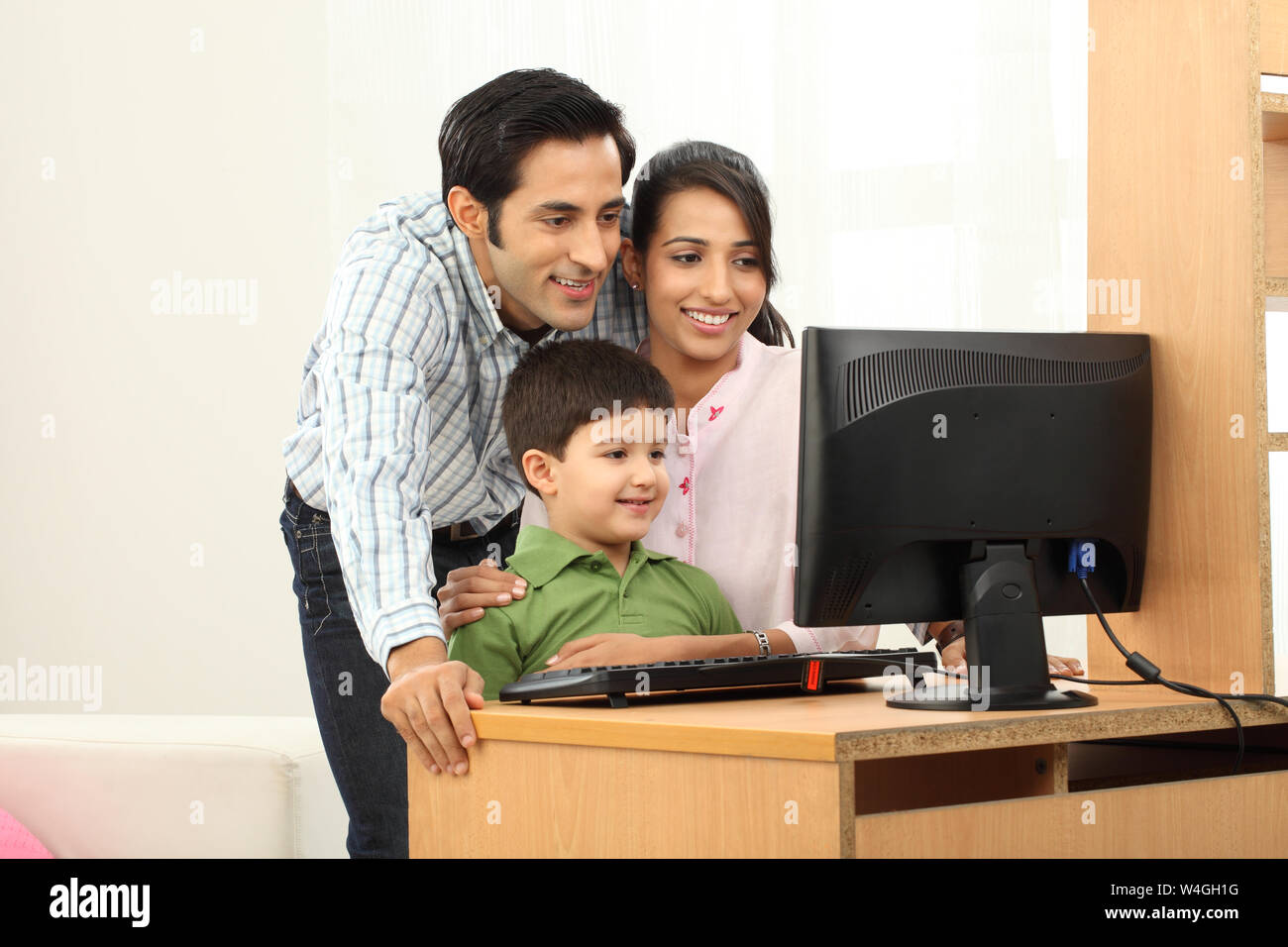 Family using a desktop pc Stock Photo Alamy